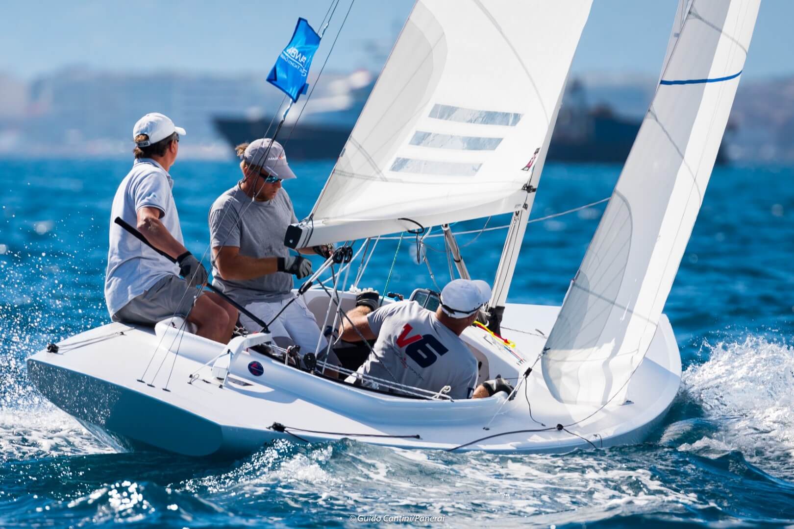 A Petticrows Dragon racing upwind in a breeze, crew hiking