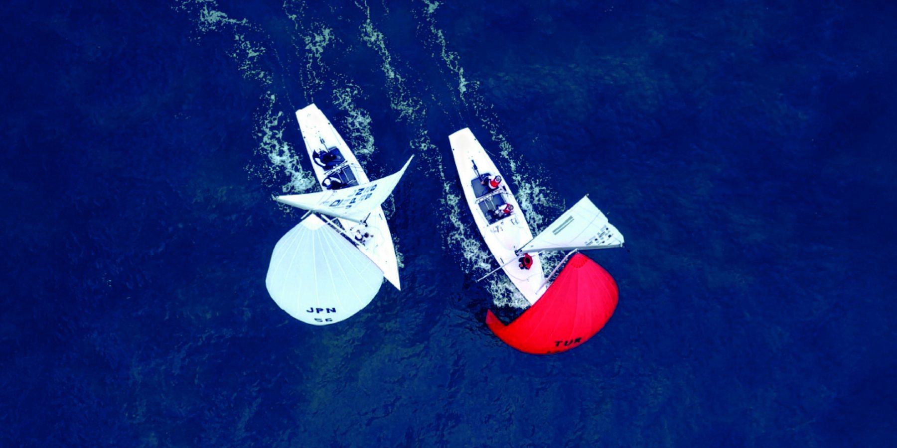 Two Dragons running downwind under spinnaker, seen from above
