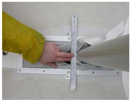 Checking the front face of the mast against the mast measurement plate with a rule (step 9).